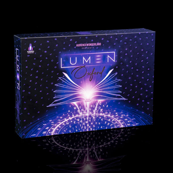 A boxed product labeled 'LUMEN Oxford' stands upright on a glossy black surface against a black background. The box art is predominantly dark blue and purple with a bright glowing white and pink burst at the center and small dotted star-like patterns across the surface.